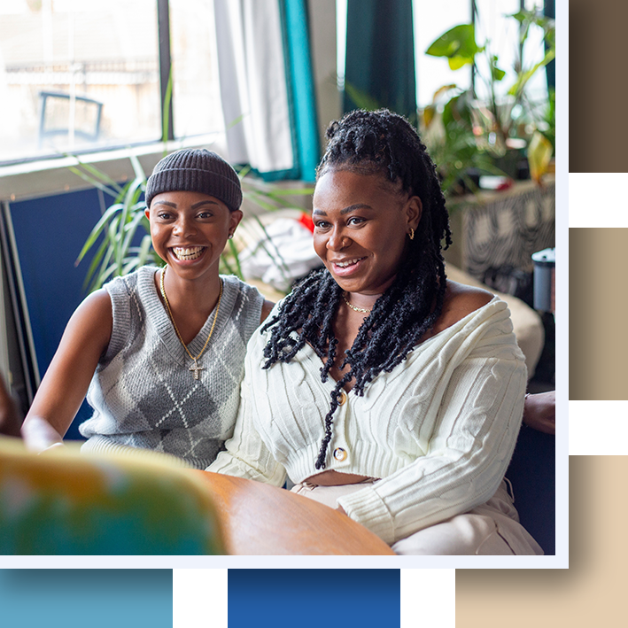 Smiling lesbian couple sitting on sofa